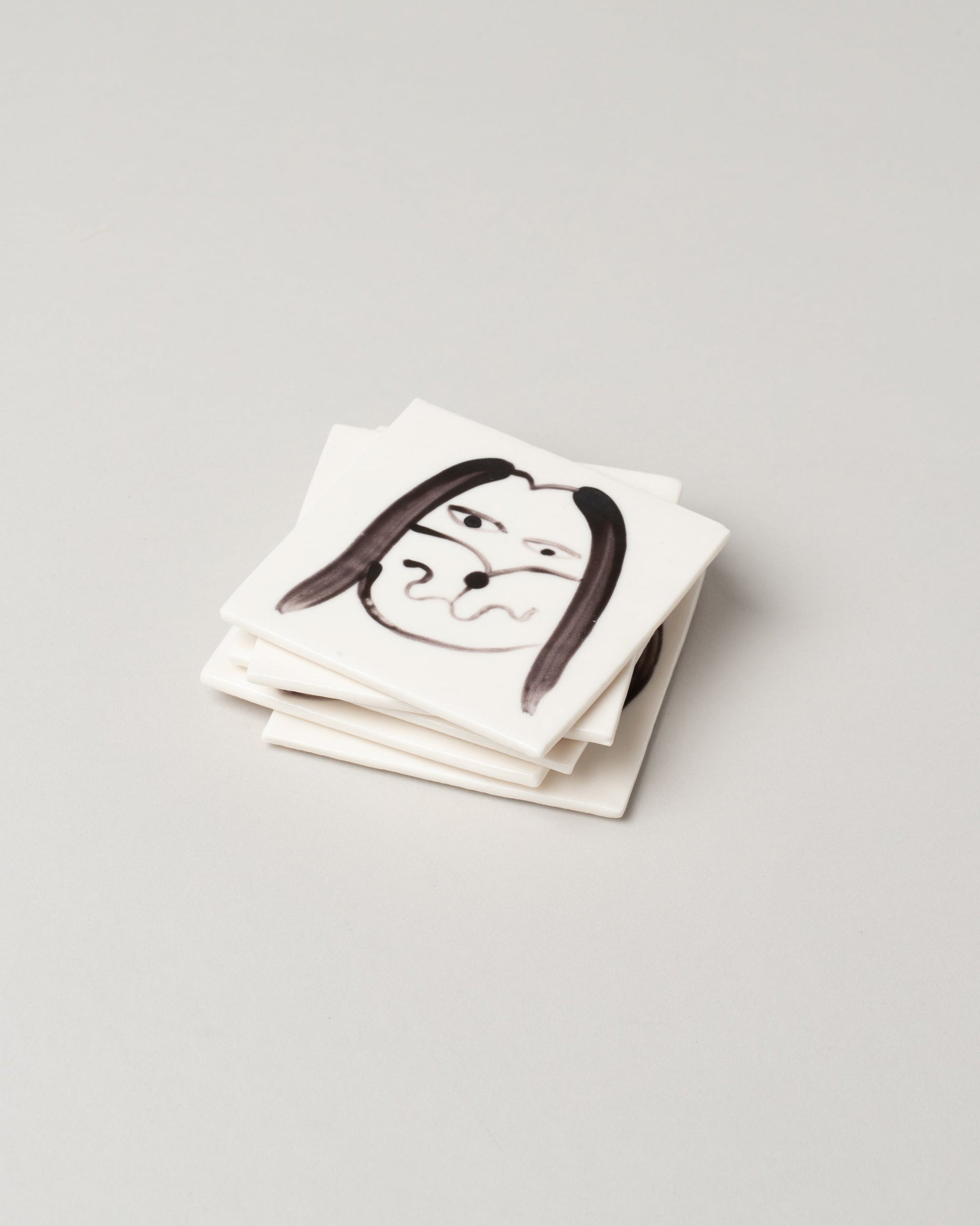 Eleonor Boström Dog Face Coasters on light color background.