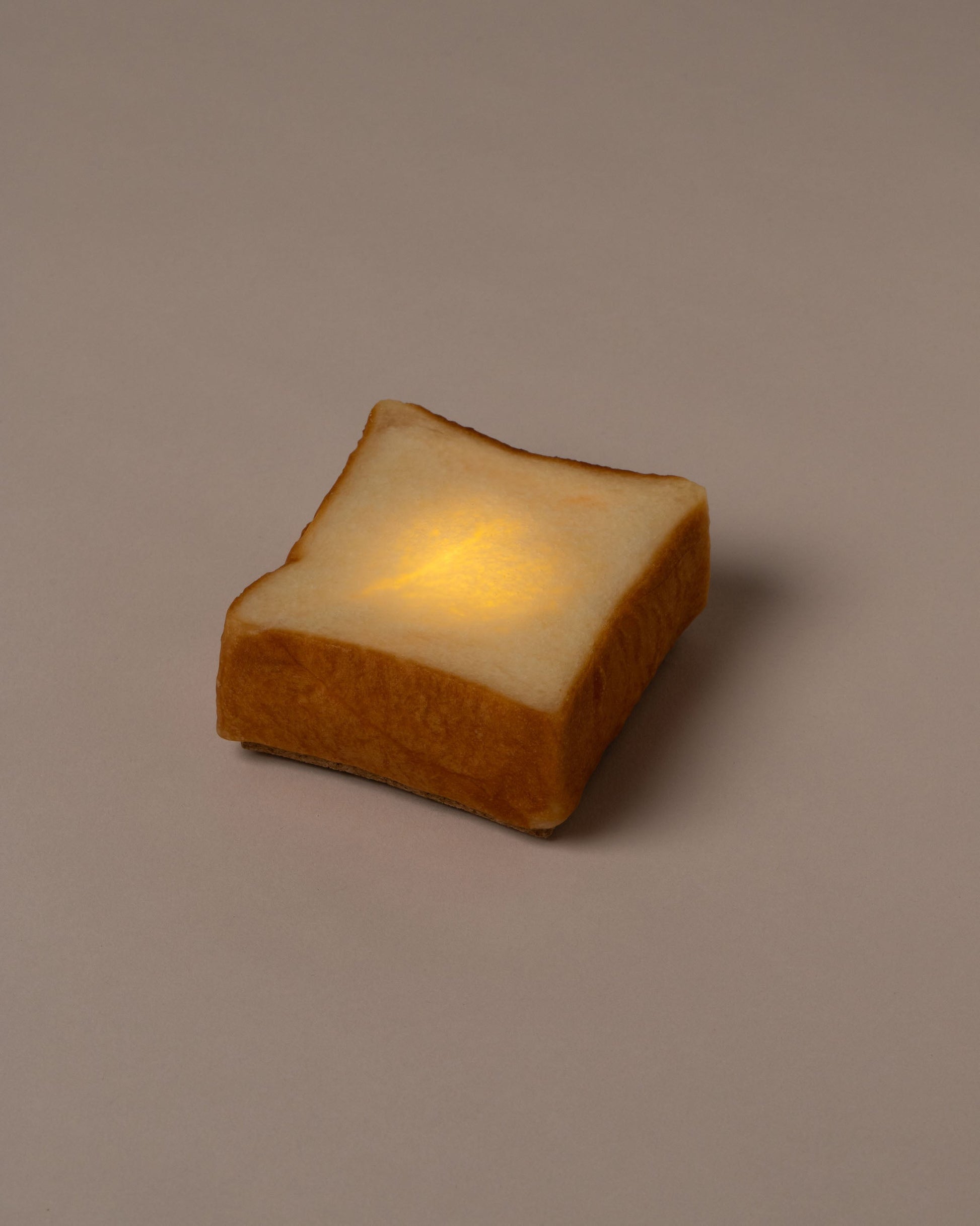 Pampshade lit Style A Toast Lamp on light color background.