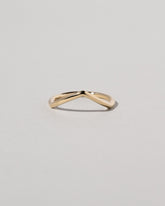 Gold Solid Round Wire Luna Peak Band on light color background.