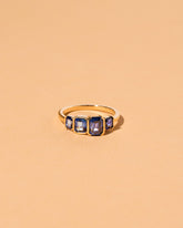 Geometric Sapphire Line Cluster Ring on light color background.