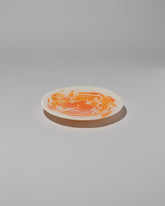 Stories of Italy Orange Nougat Dessert Plate on light color background.