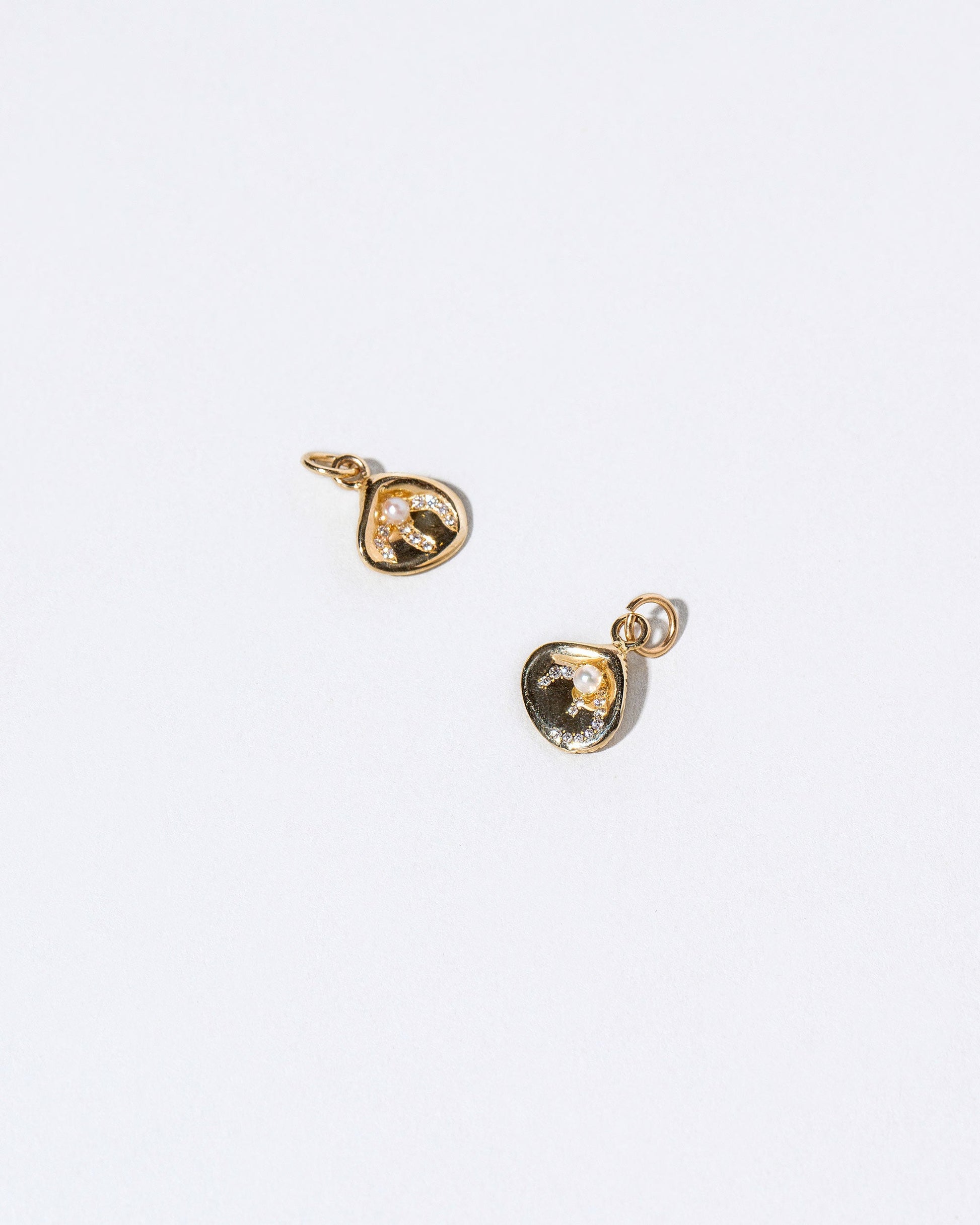  Clams Casino Charm on light color background.