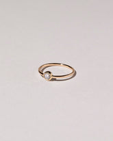 View from the side of the Rose Cut Purple Diamond Ring on light color background.
