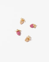 Wild Strawberry Charm, Diamond & Ruby Pavé Strawberry Charm and Ruby Pavé Strawberry Charm on light color background.