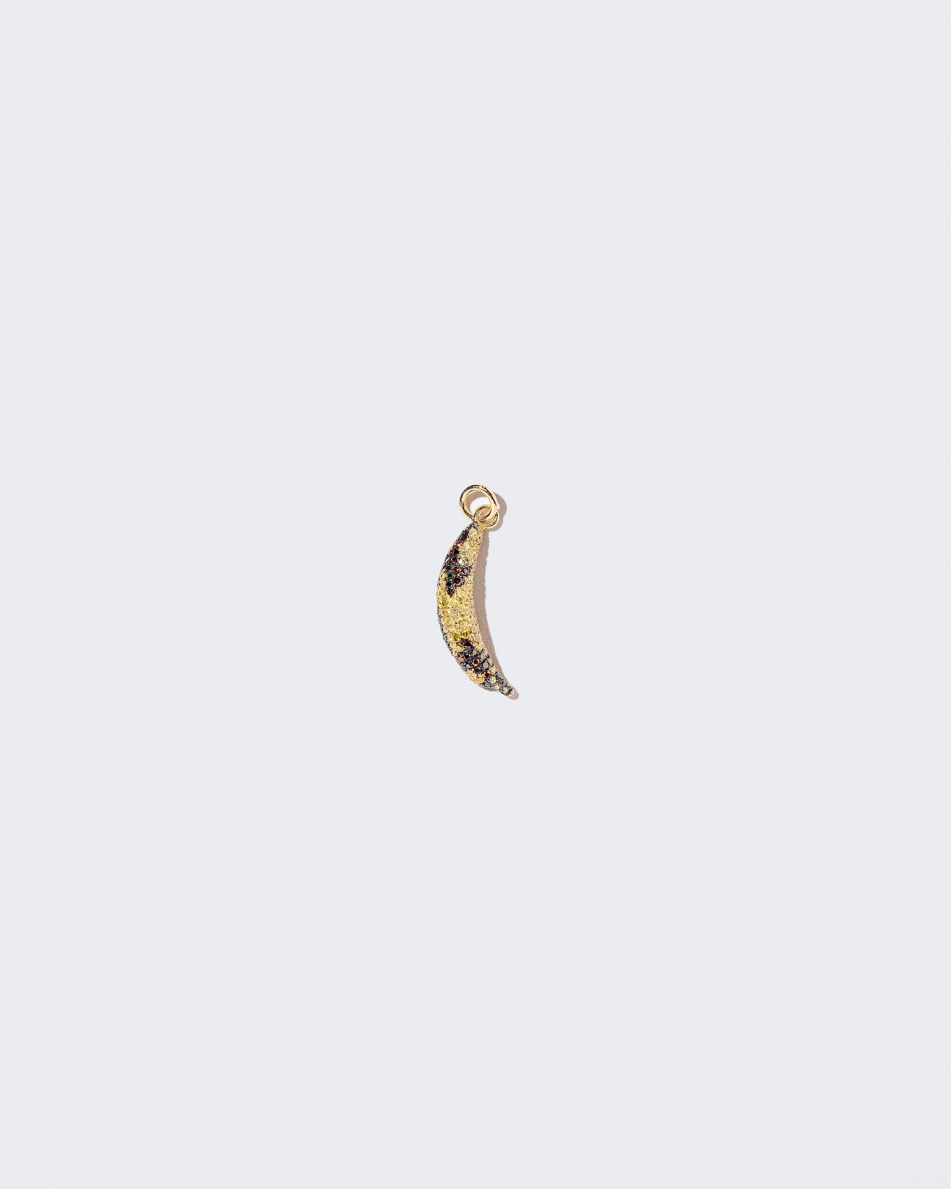 Bruised Banana Charm on light color background.