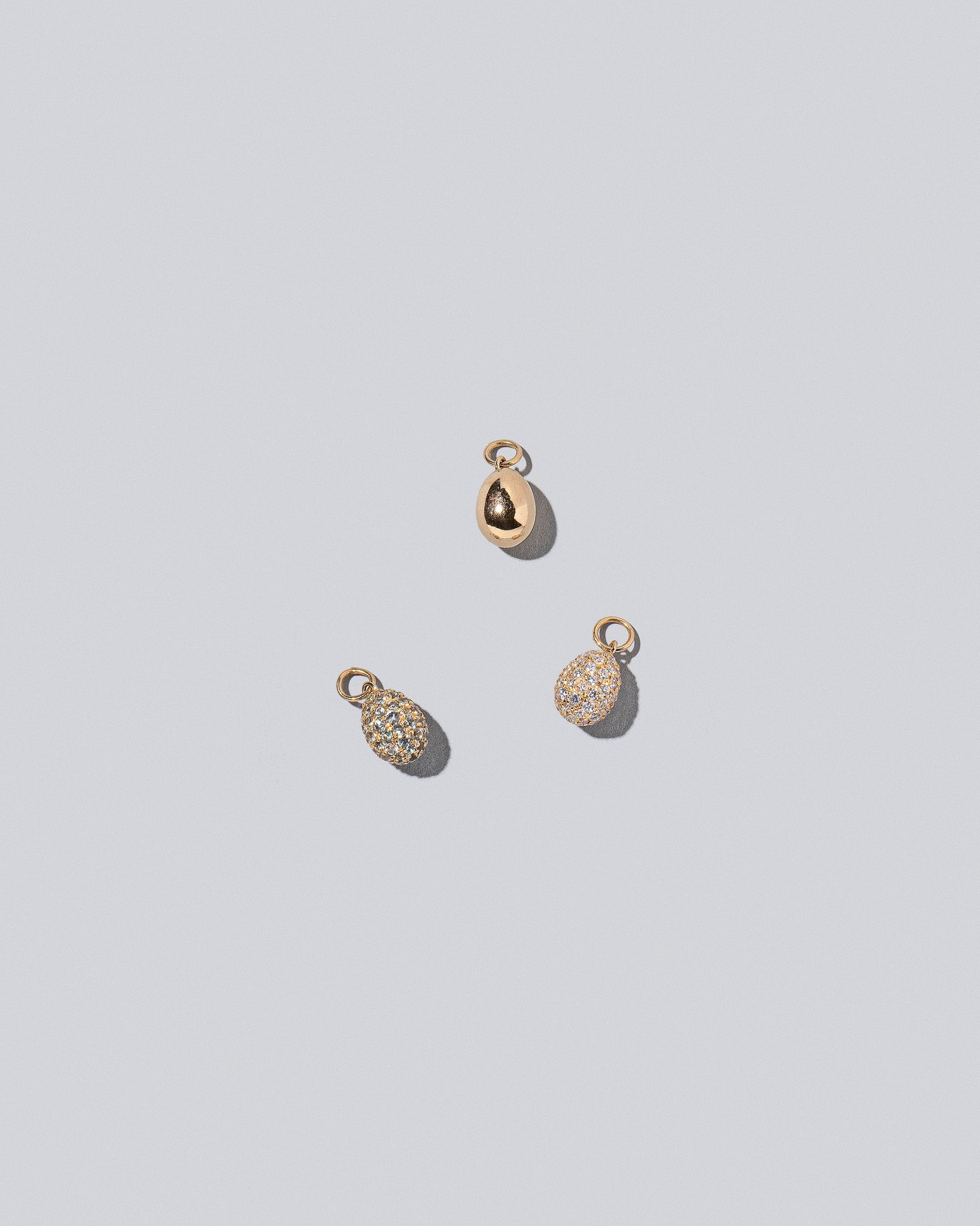 Egg Charms on light color background.