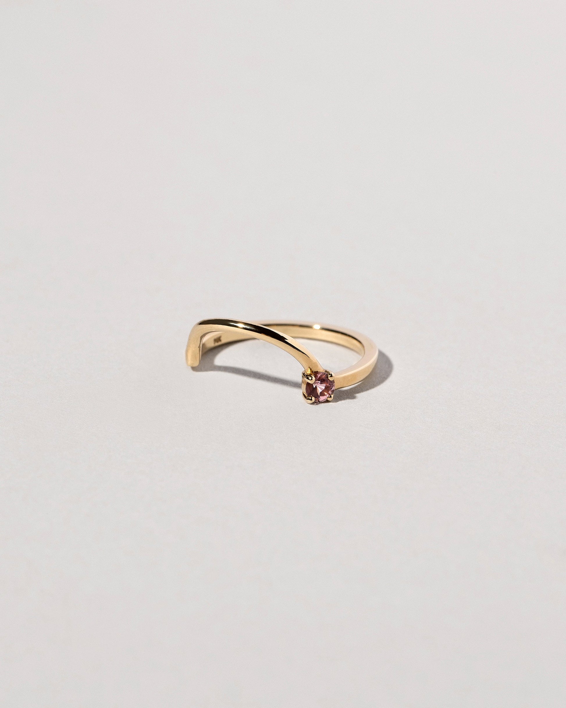 View from the side of the Yellow Gold Spinel Half Hoop Band on light color background.