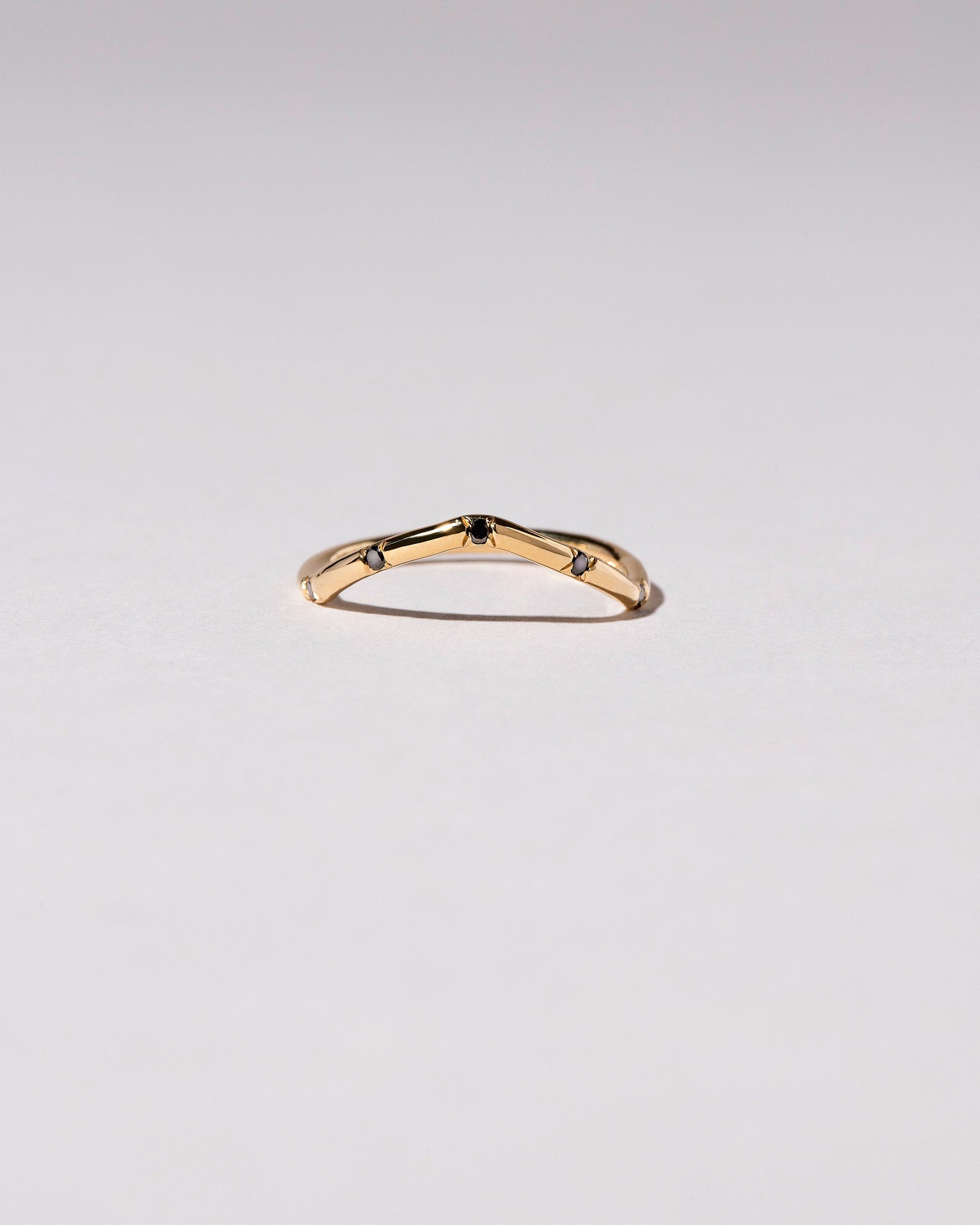Gold Black Diamond Five Stone Low Peak Band on light color background.