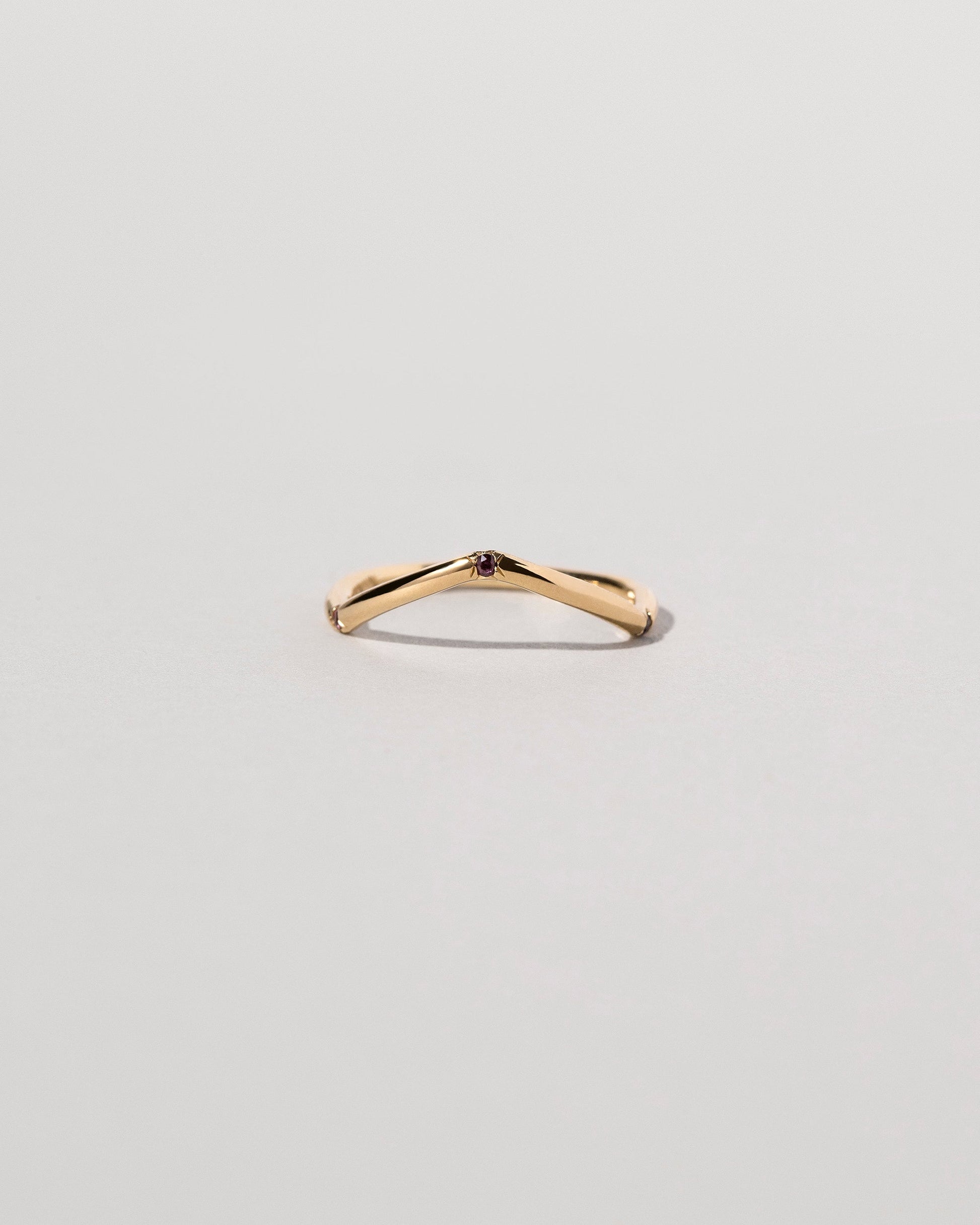 Gold Three Stone Black Diamond Low Peak Band on light color background.