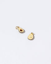 Closeup details of the Halved Avocado Charms on light color background.