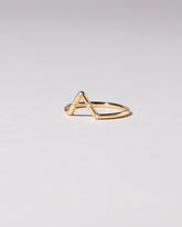 View from the side of the Gold White Diamond Five Stone Triangle Band on light color background.