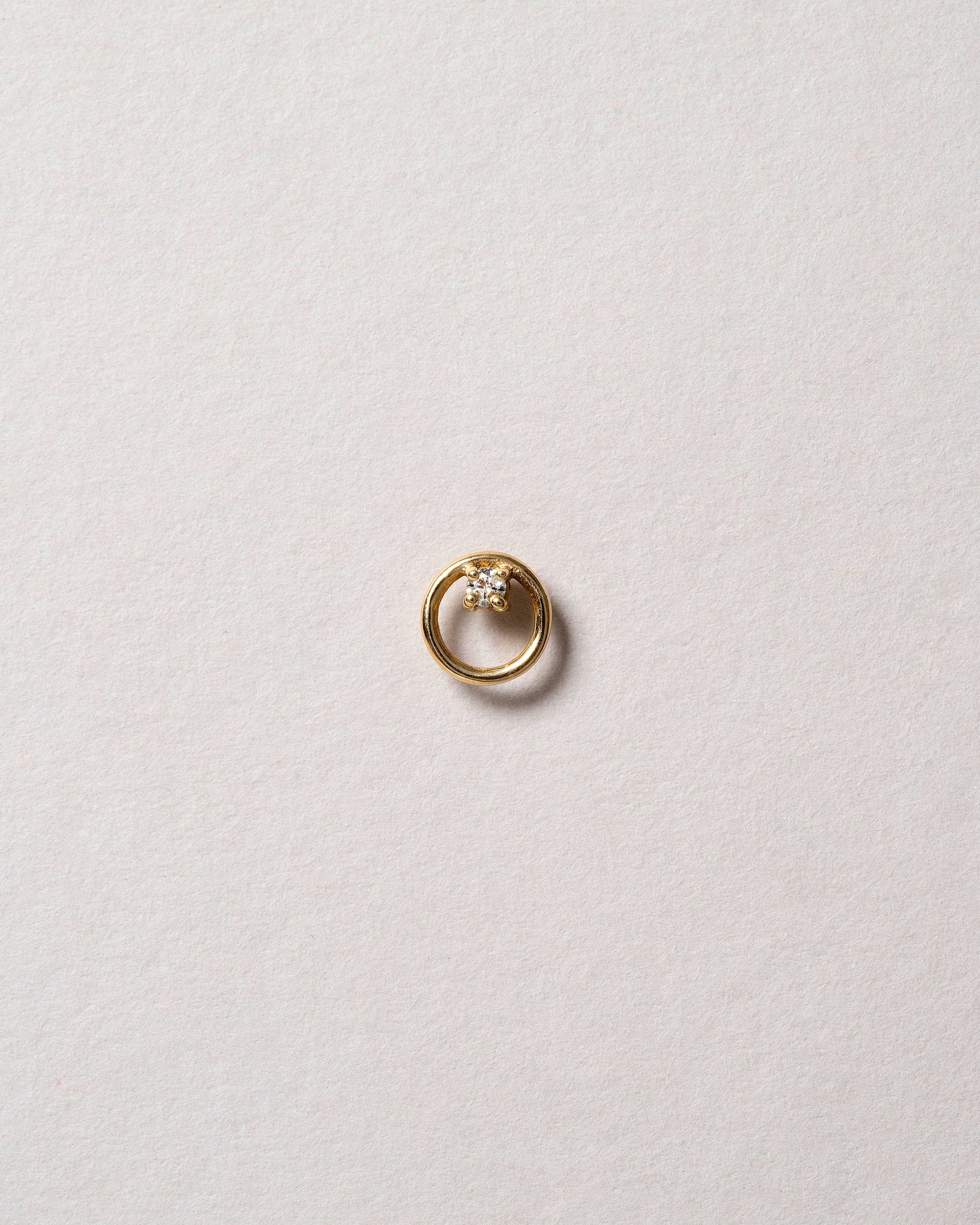 Gold White Diamond Full Moon Stud Earring Single on light color background.