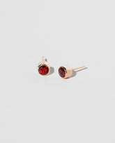  Garnet Studs on light color background.