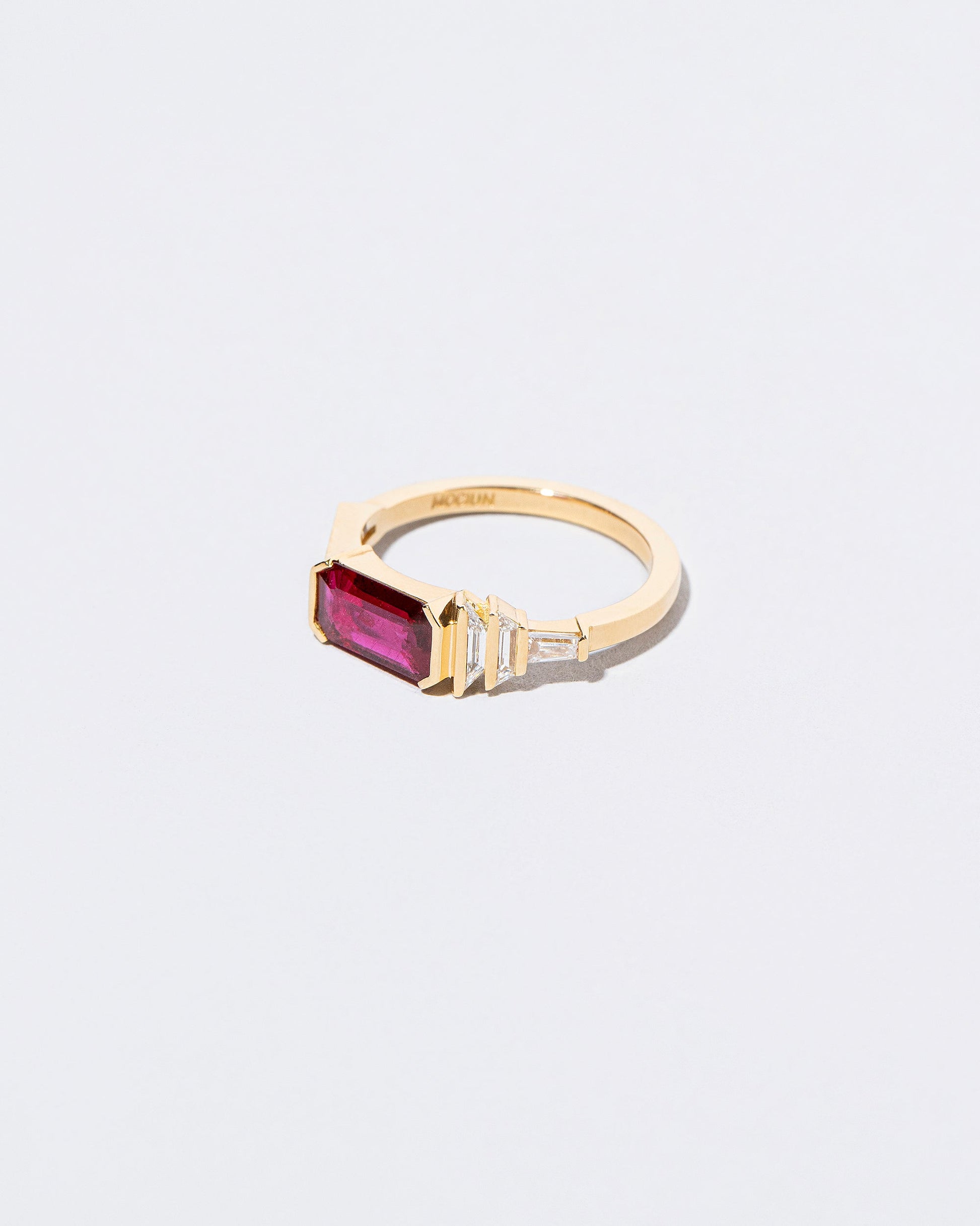 View from the side of the Femme Volage Ring on light color background.