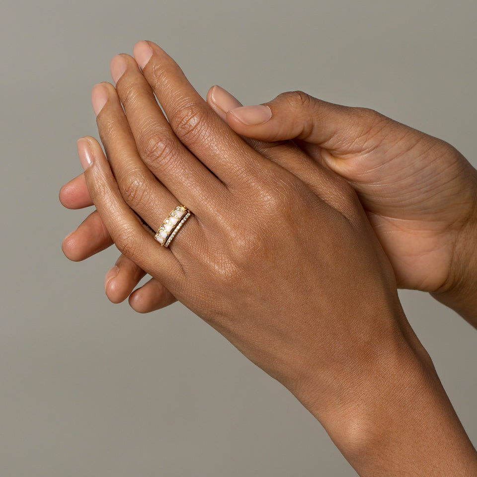 product_details::Gold Notched Band and Gold White Opal Five Triangle Ring on model.
