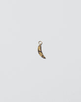 Bruised Banana Charm on light color background.