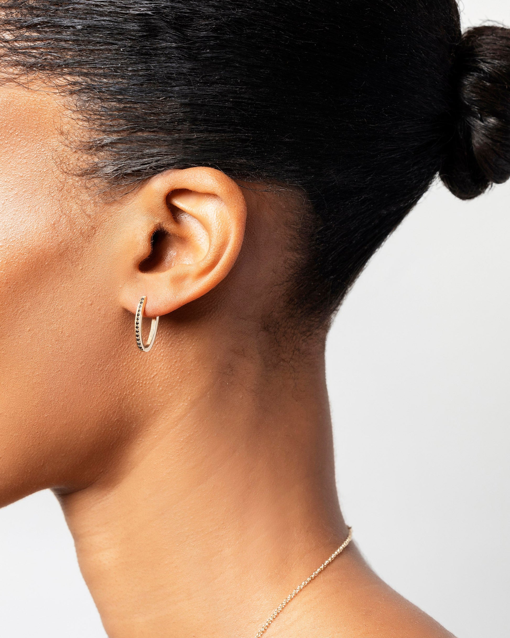 Gold Black Diamond Tiny Loop Hoop Earrings on model.