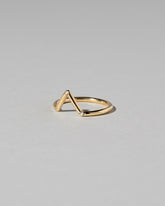 View from the side of the Gold White Diamond Three Stone Triangle Band on light color background.