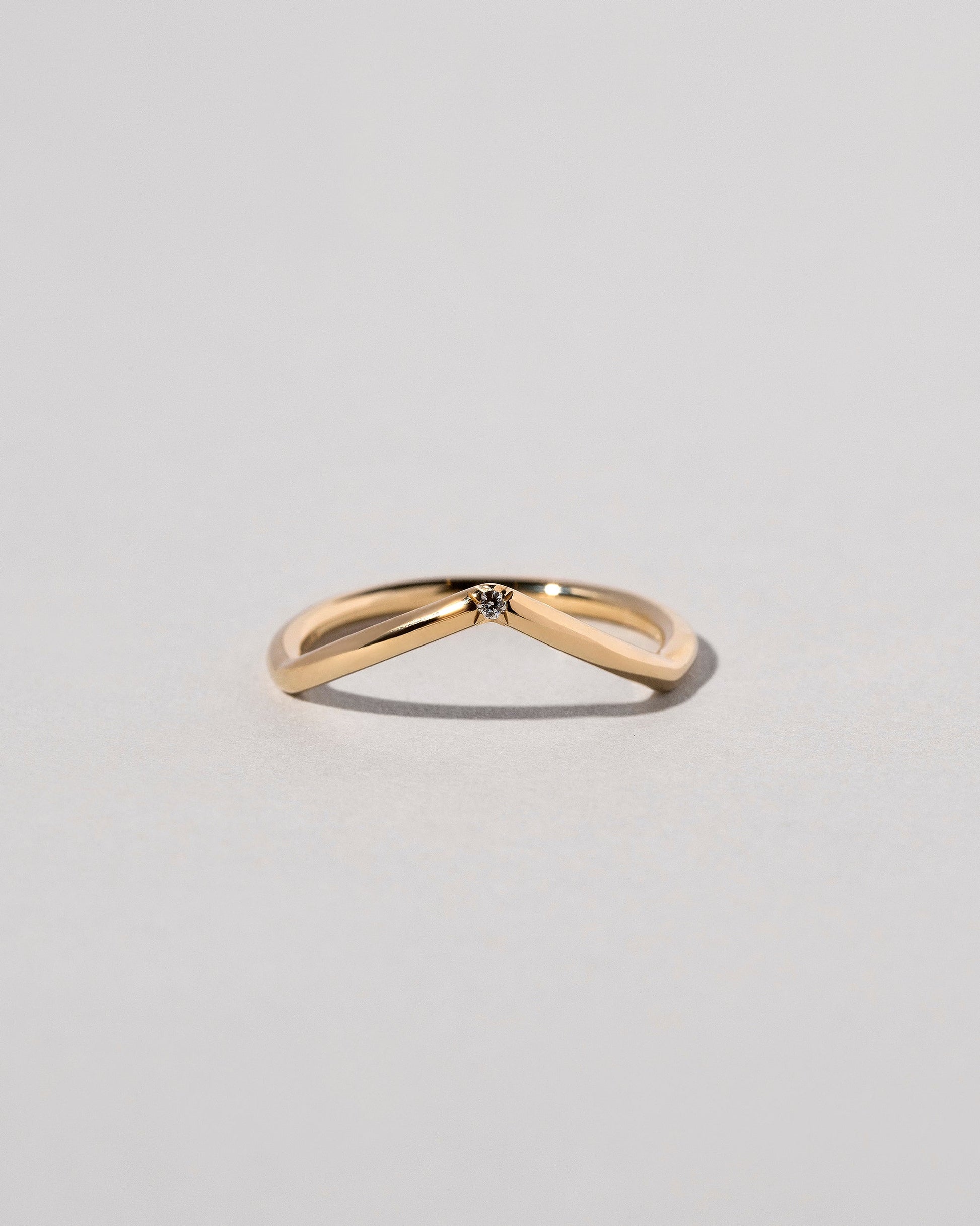 Gold White Diamond Single Stone Luna Peak Band on light color background.