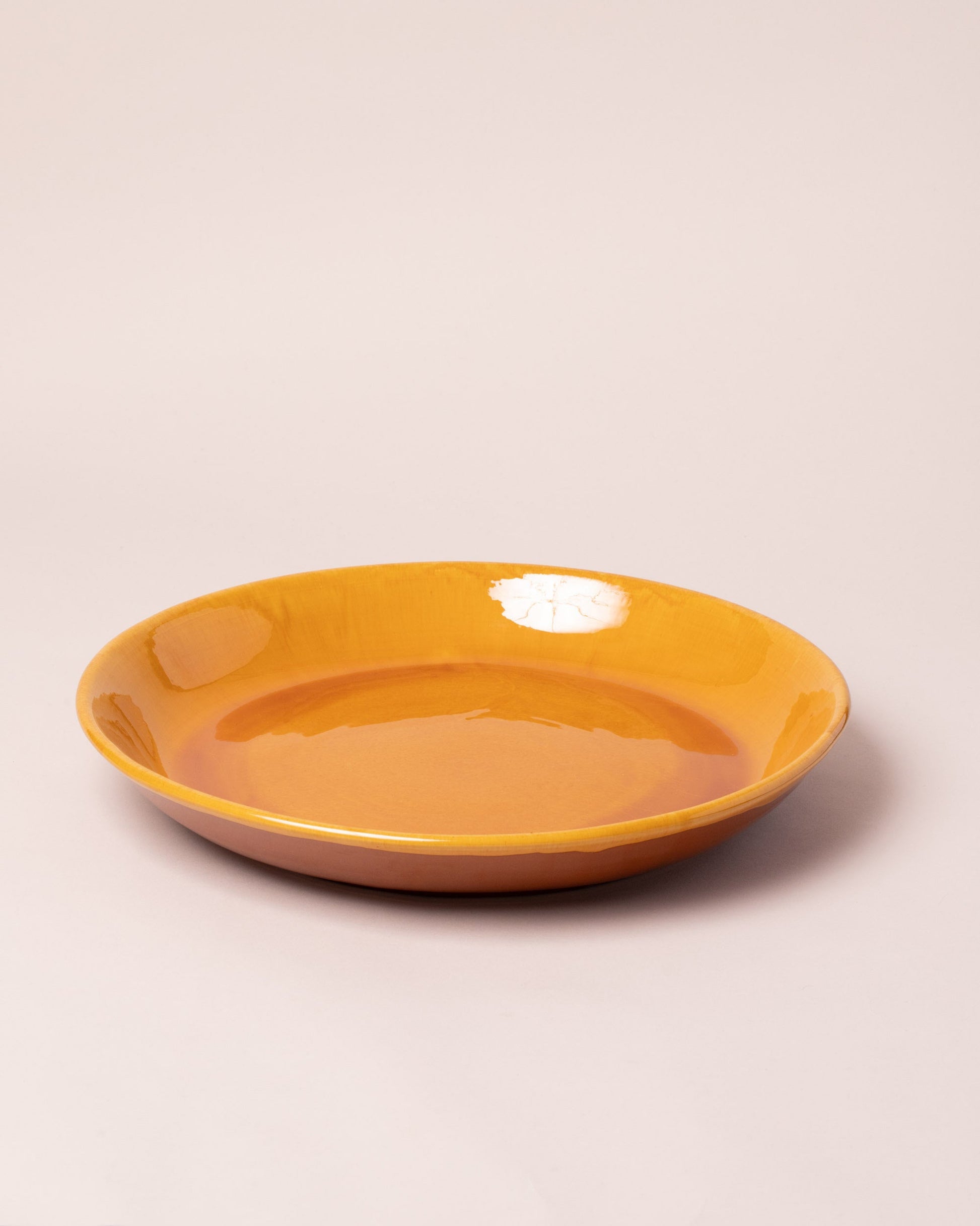  Del Monaco Circular Serving Dish on light color background.