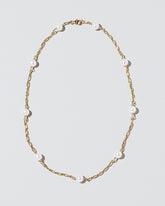  Pearl Station Necklace on light color background.