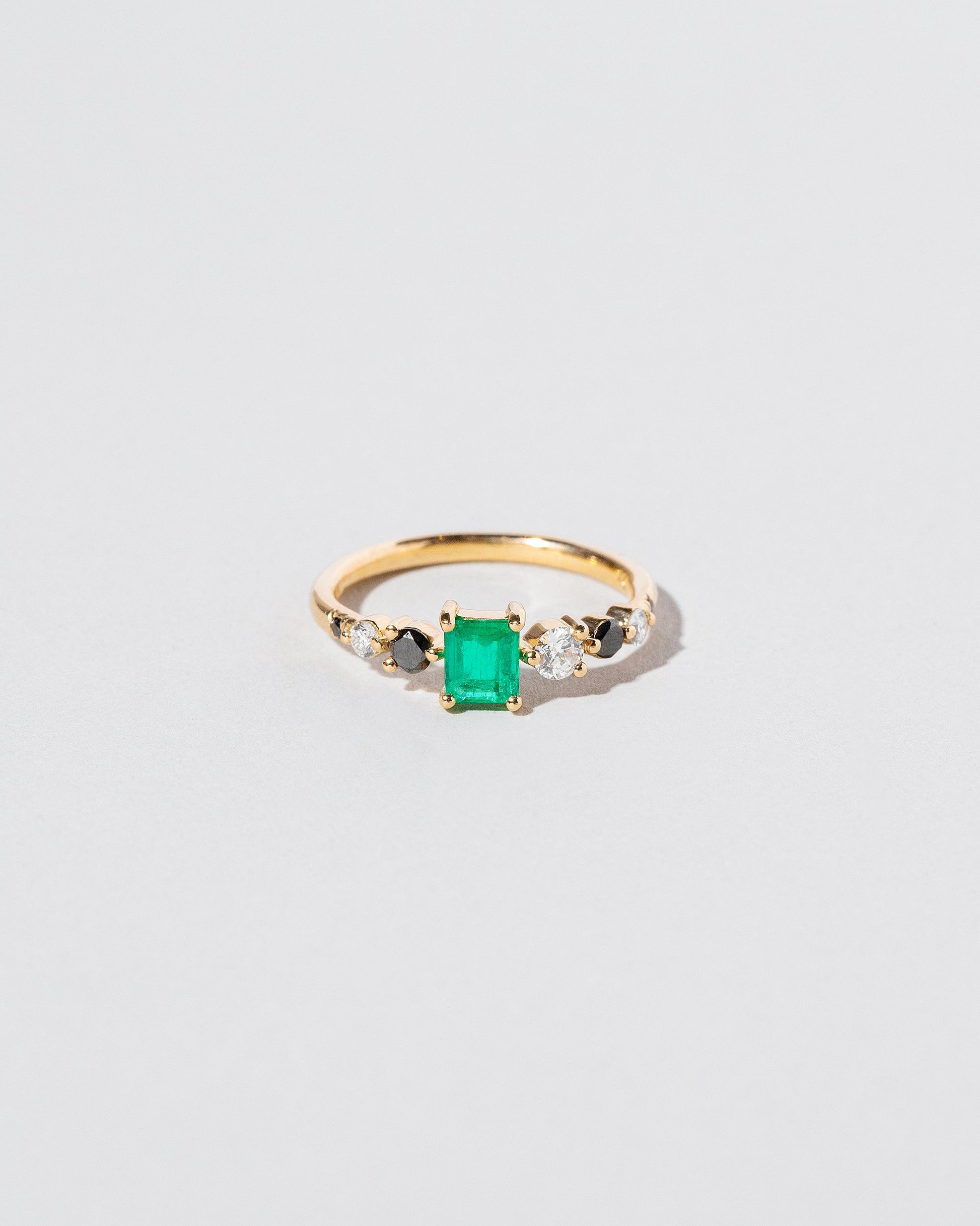 Emerald Seven Sisters Ring on light color background.