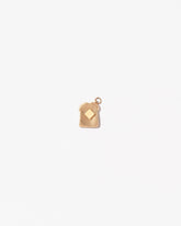 Buttered Toast Charm on light color background.