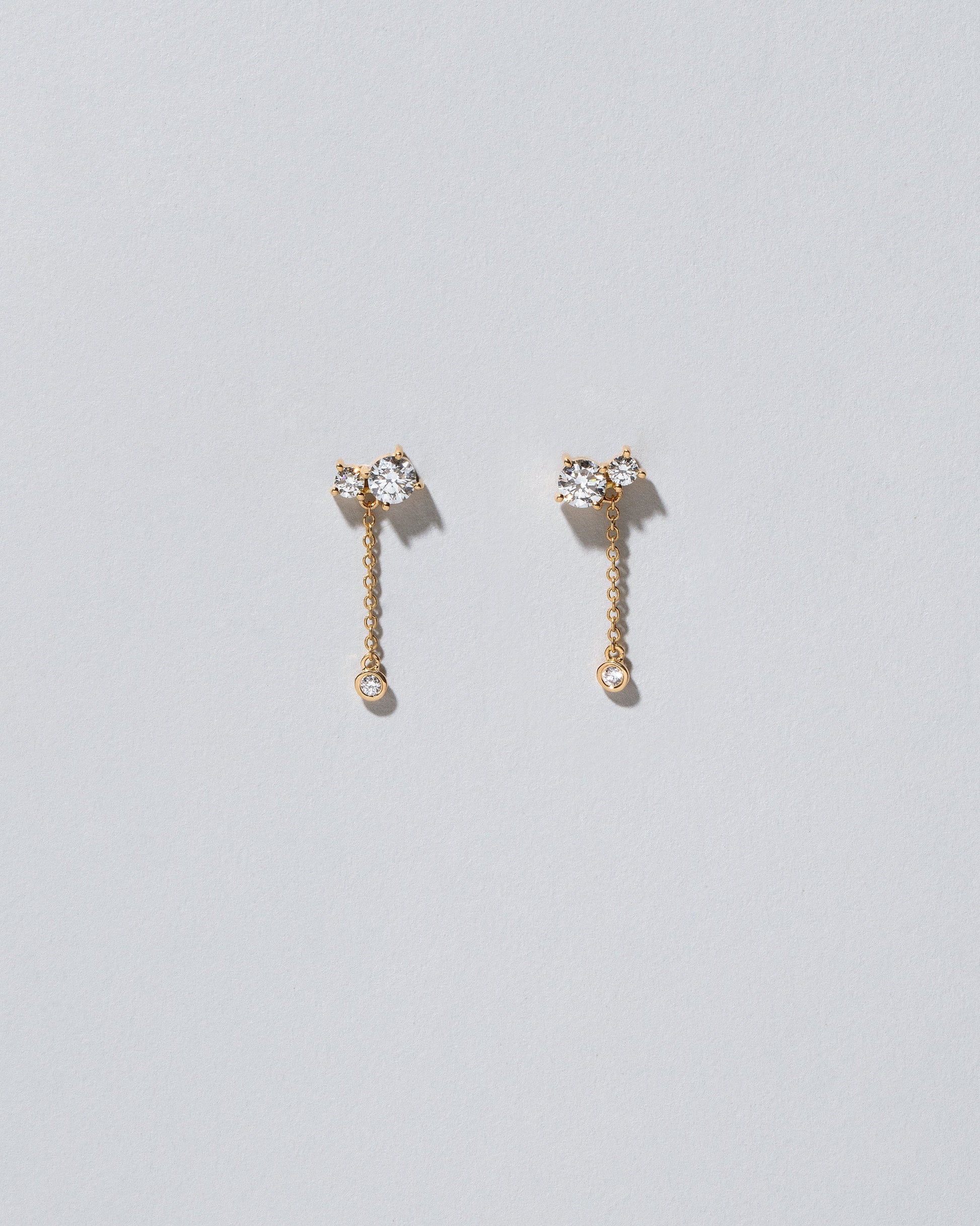 Drop Aster Earrings on light color background.