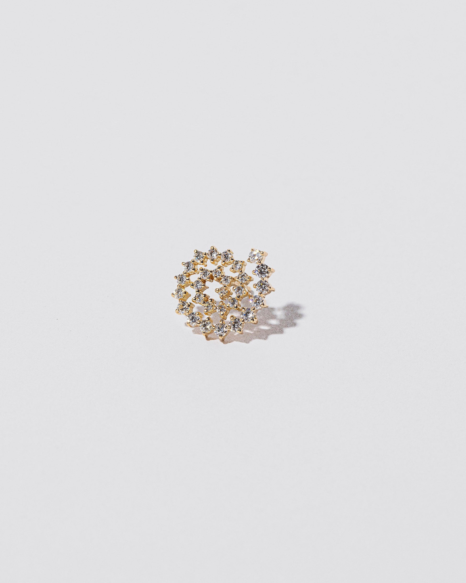 Full White Diamond Left Spiral Stud Earring Single on light color background.