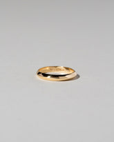 Gold 2.5mm Knife Edge Band on light color background.