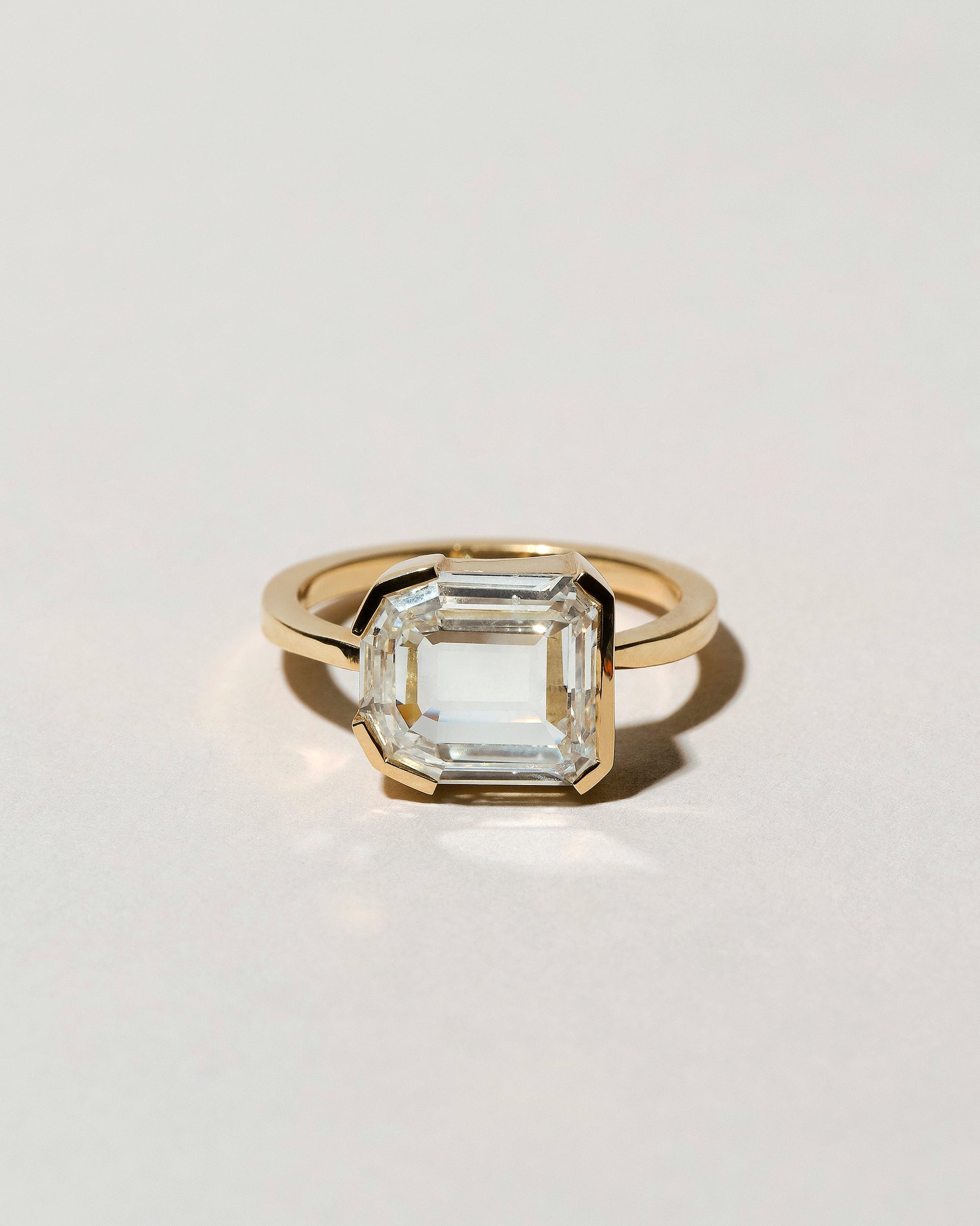 Shield Step Cut Diamond Ring on light color background.