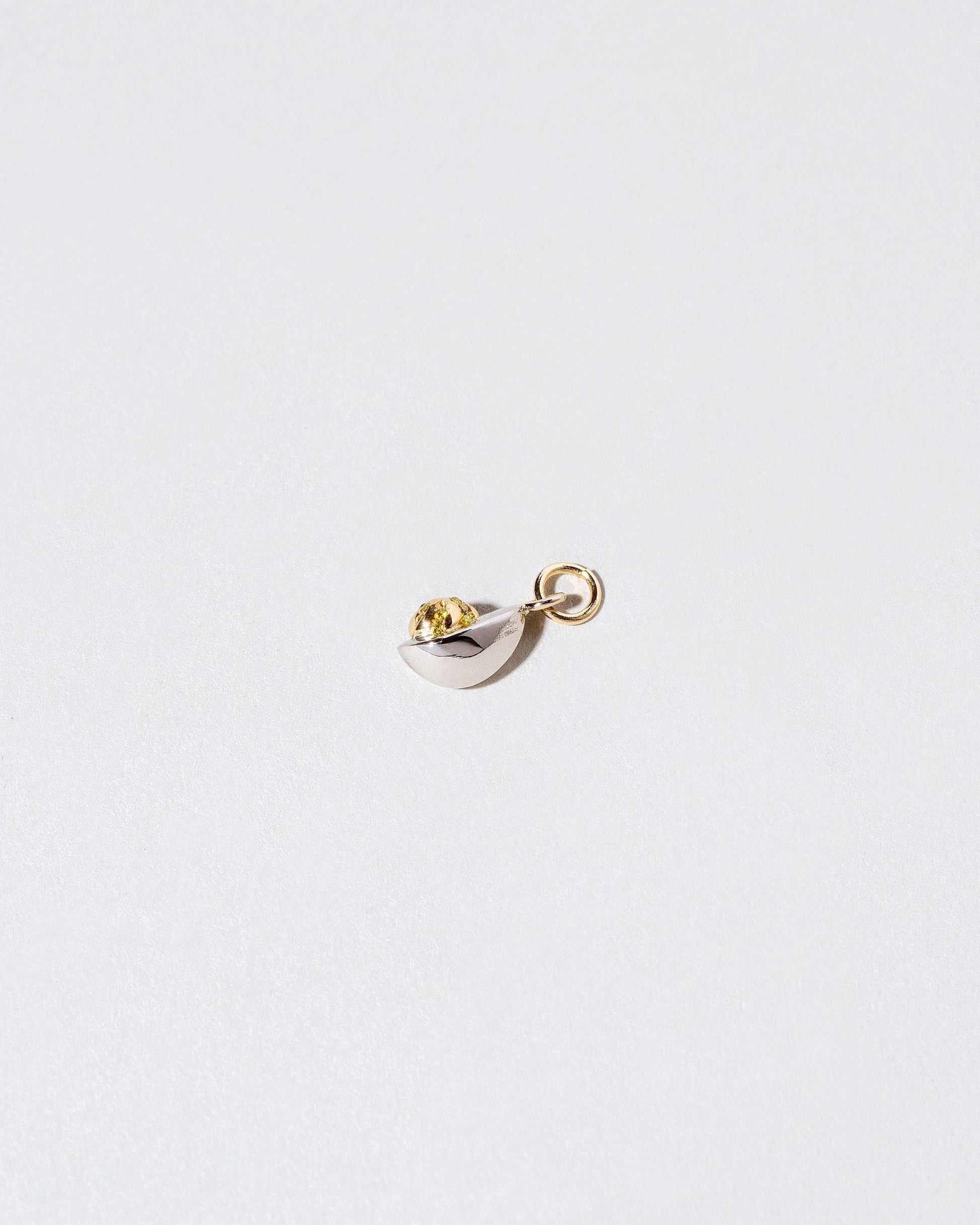 Closeup details of the Deviled Egg Charm on light color background.