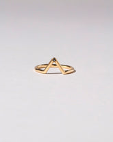 Gold Single Burnish-Set Black Diamond Triangle Band on light color background.