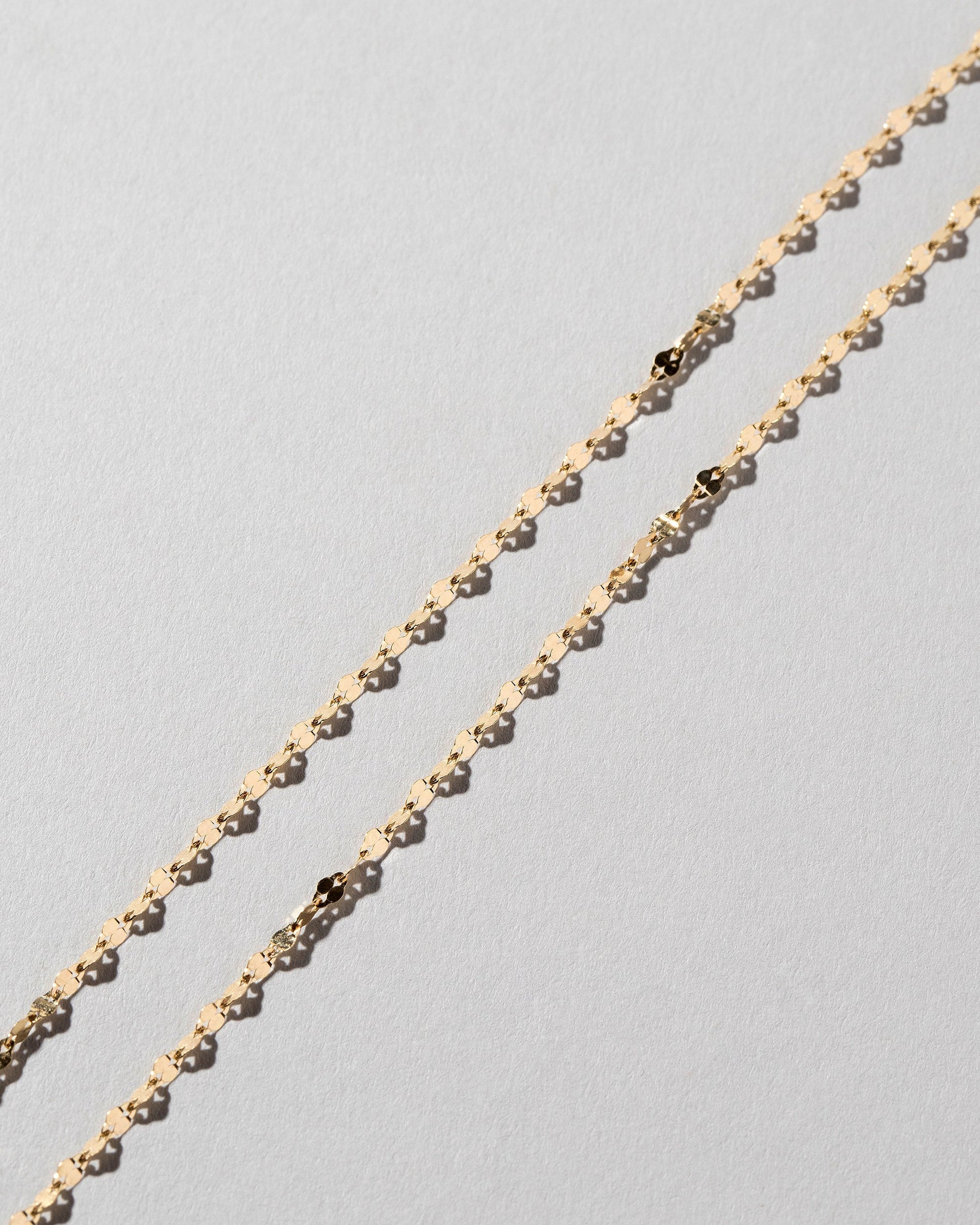  Streamer Chain Necklace on light color background.