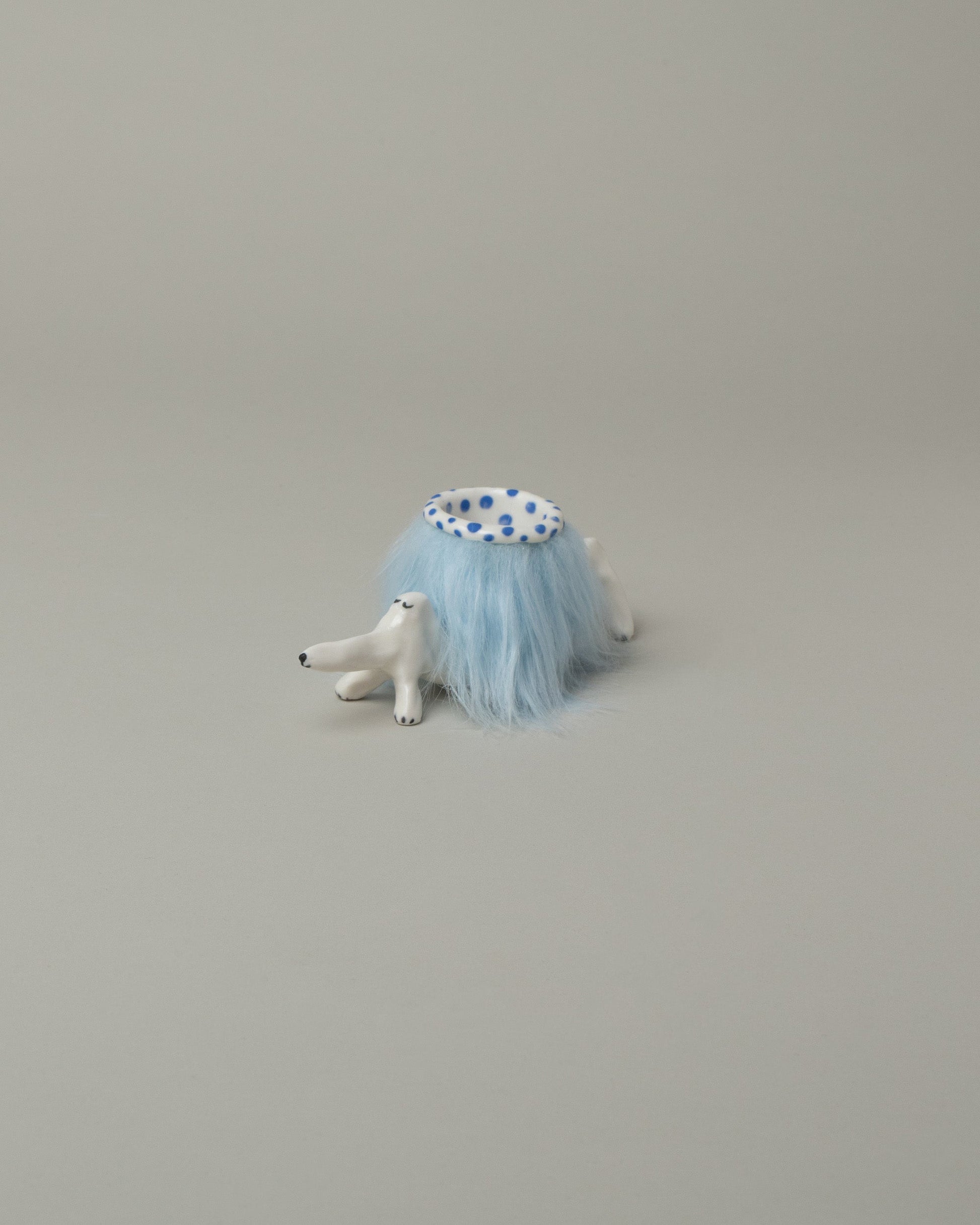 Eleonor Boström Blue Furry Baggage Dog on light color background.