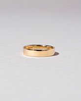 Closeup detail of the Gold 5mm Square Wire Band on light color background.