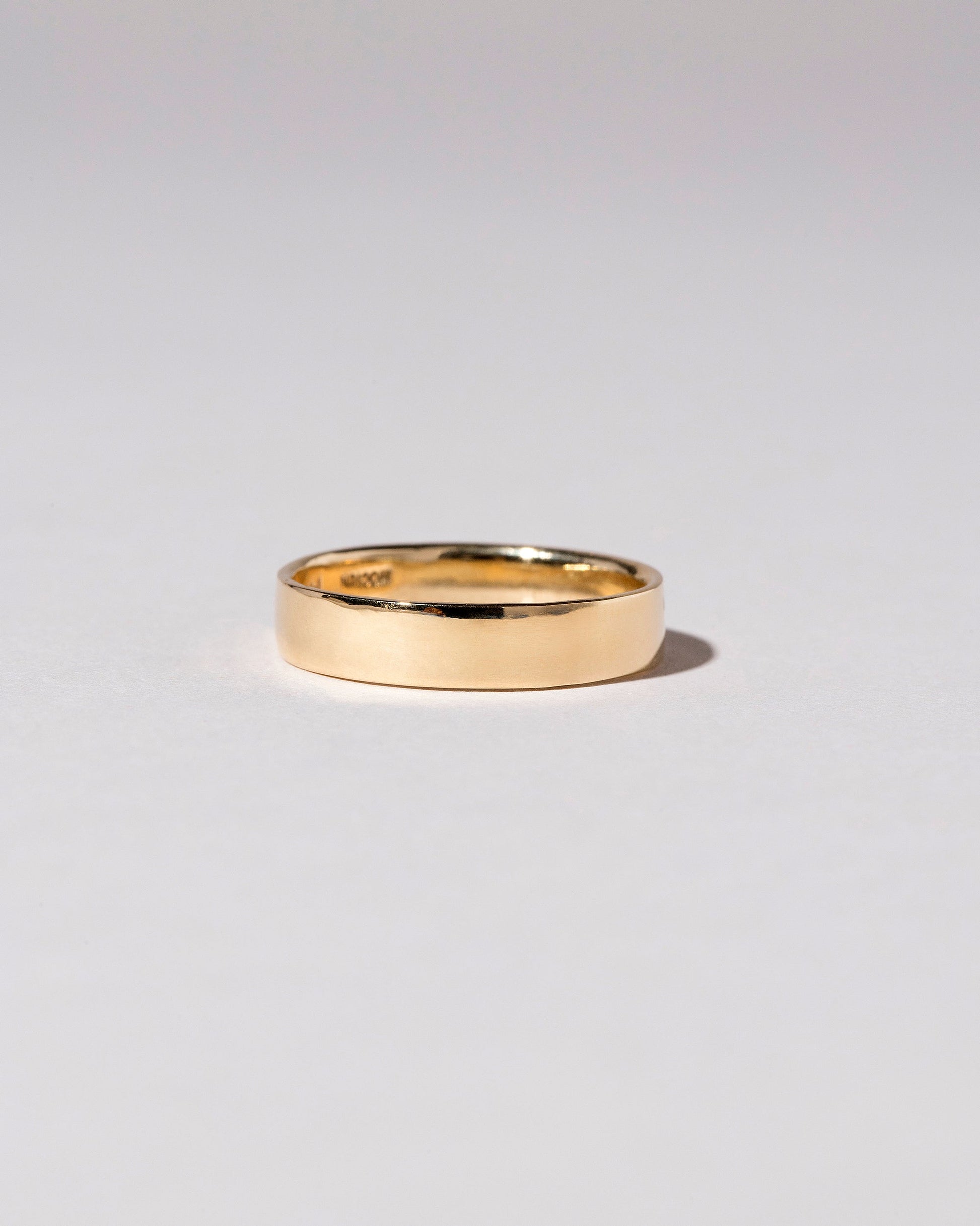 Closeup detail of the Gold 5mm Square Wire Band on light color background.