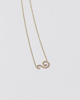 White Diamond Symbol of Change Necklace on light color background.