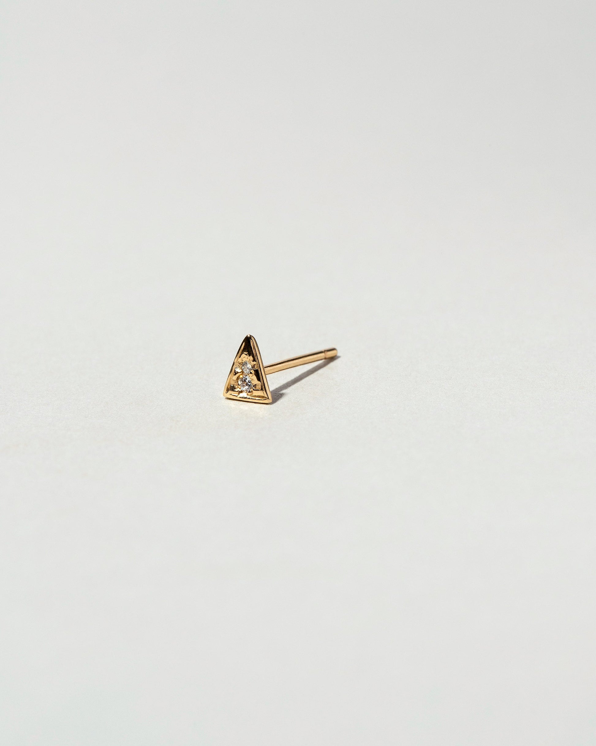 Gold White Diamond Triangle Stud Earring Single on light color background.