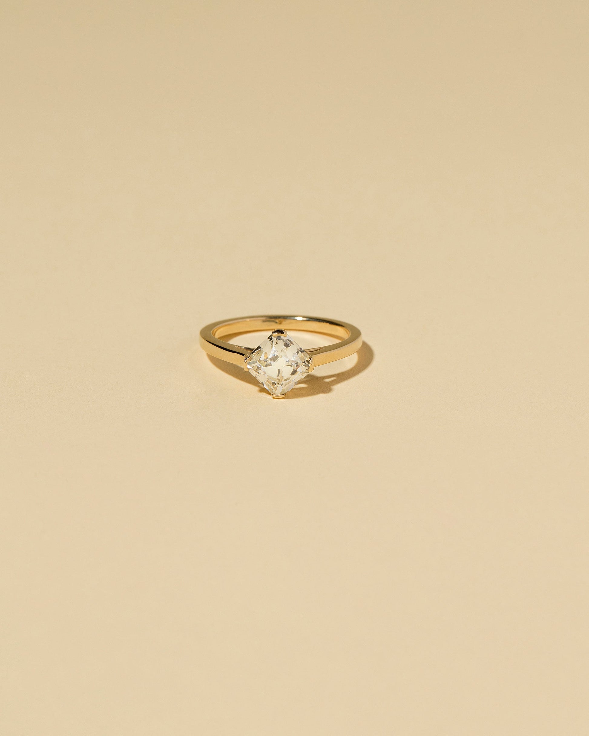 Cushion Modified Brilliant Diamond Solitaire Ring on light color background.