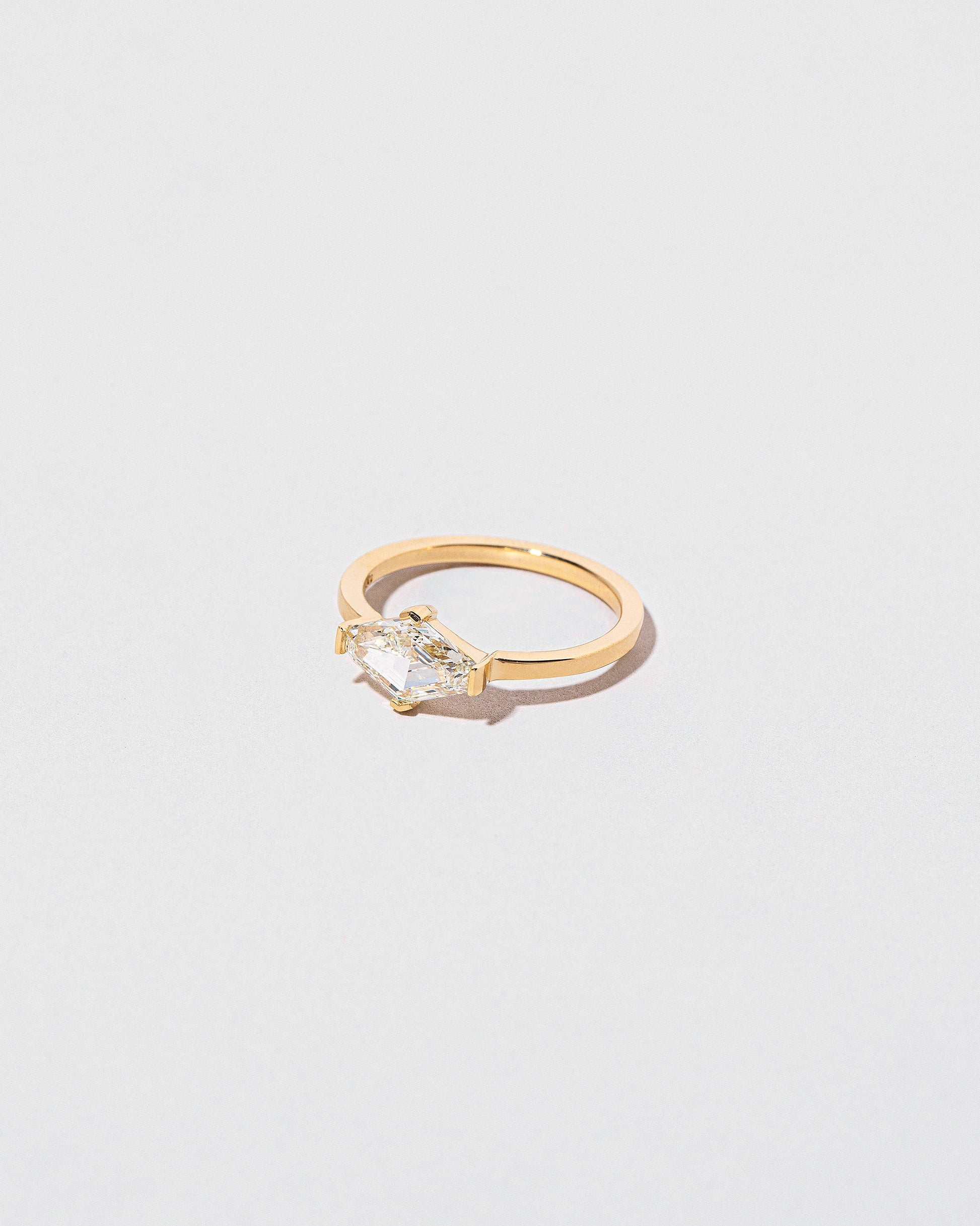 View from the side of the Divine Geometry Ring on light color background.