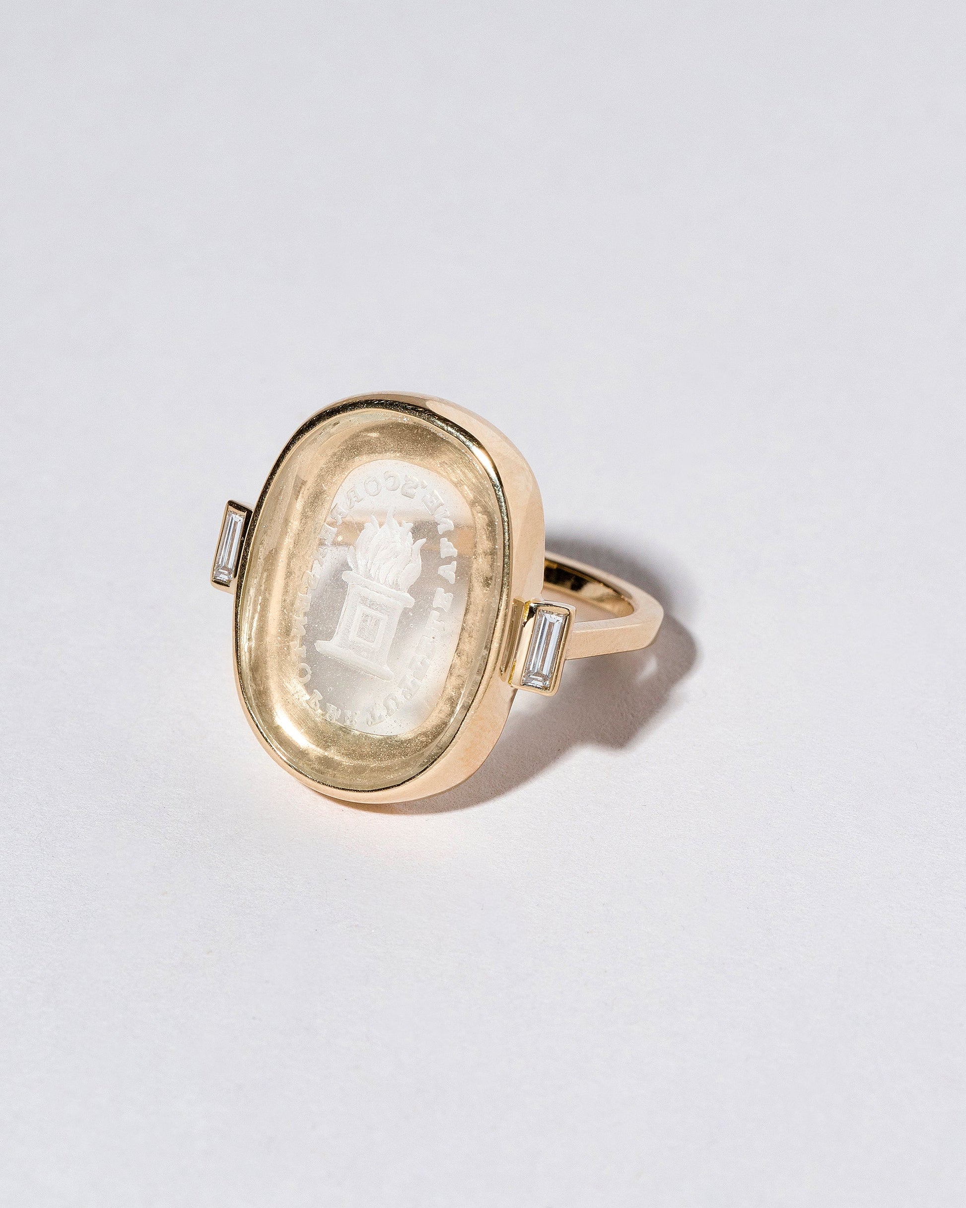 Closeup details of the Passion Intaglio Seal Ring on light color background.