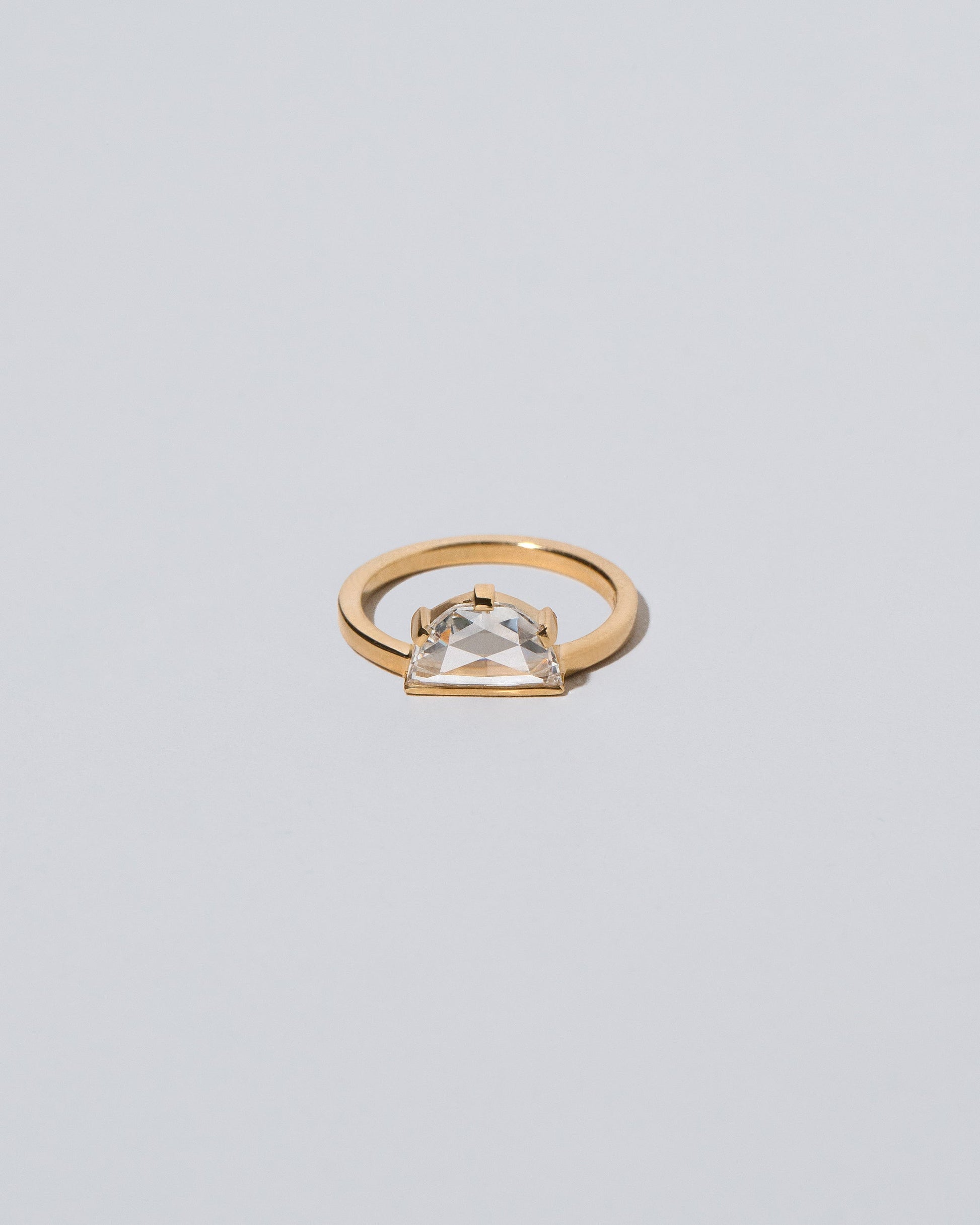 Plié Ring on light color background.