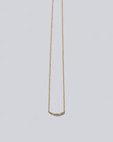 Champagne Diamond Crescent Necklace on light color background.