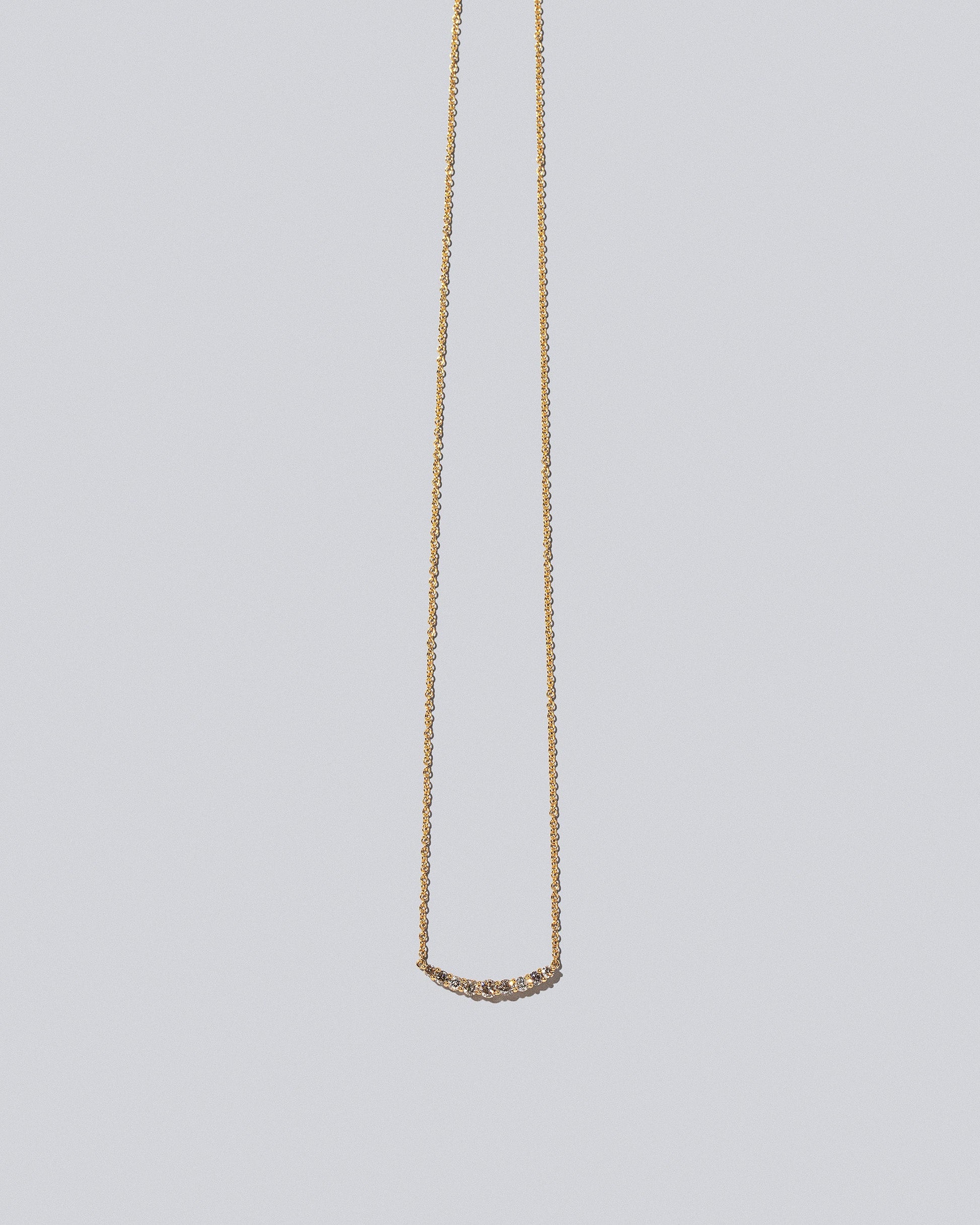 Champagne Diamond Crescent Necklace on light color background.