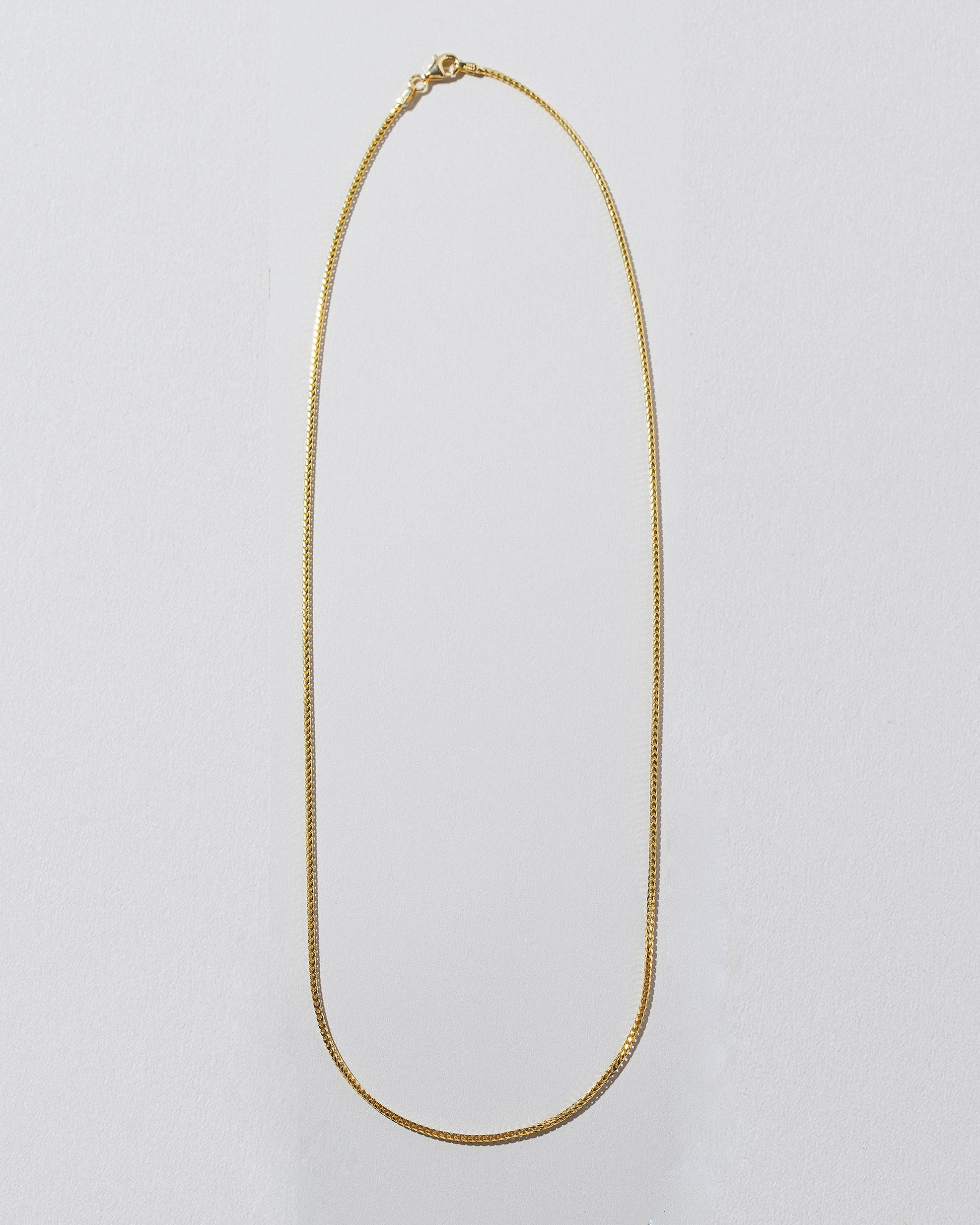 1mm Ritual Chain Necklace on light color background.