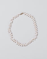 Large Zipper Pearl Necklace on light color background.