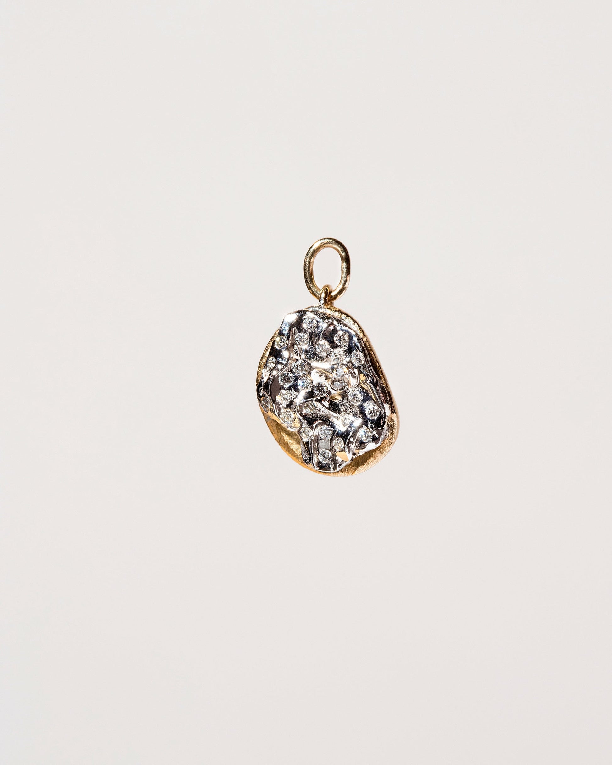 Plain Bagel Charm with Diamond Cream Cheese on light color background.