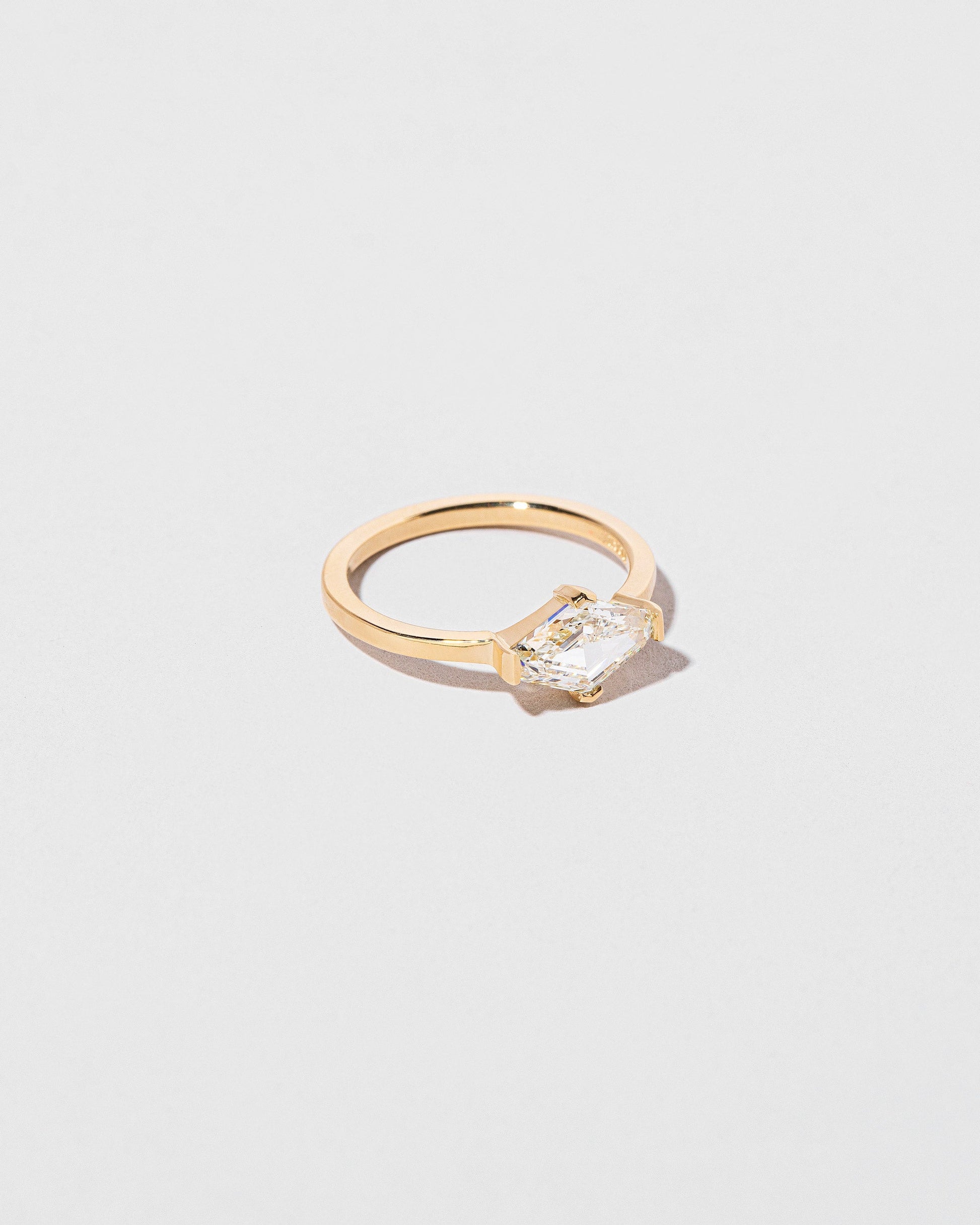 View from the side of the Divine Geometry Ring on light color background.