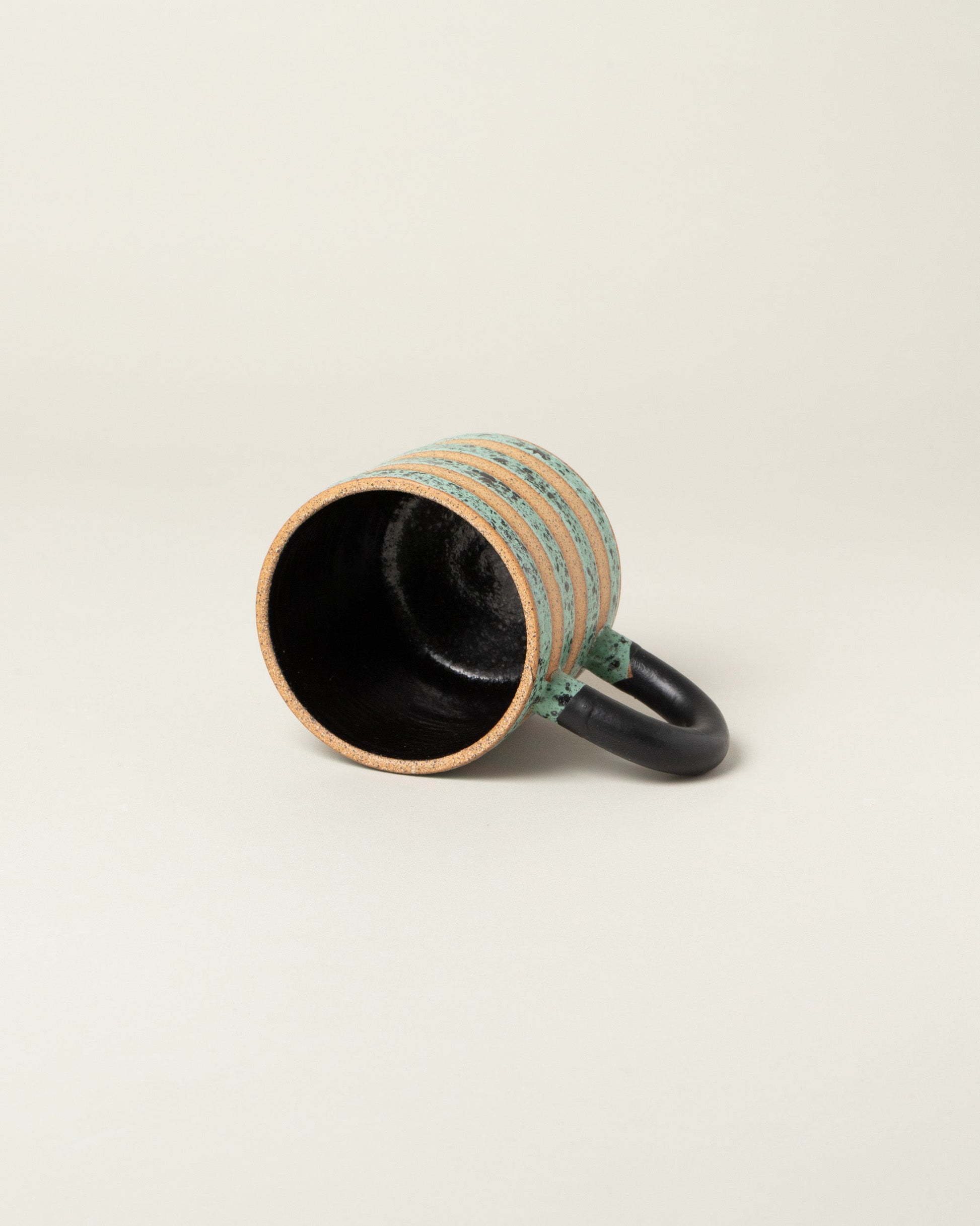 Detail view of Recreation Center Dalmatian Stripe Mugs on light color background.